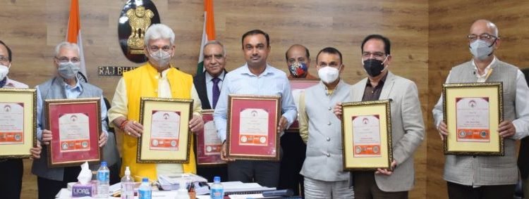 LG releases Silver Souvenir Coin; Inaugurates e-library & Board approves Grant-in-Aid for the FY 2021-22 to SMVD Charitable Society