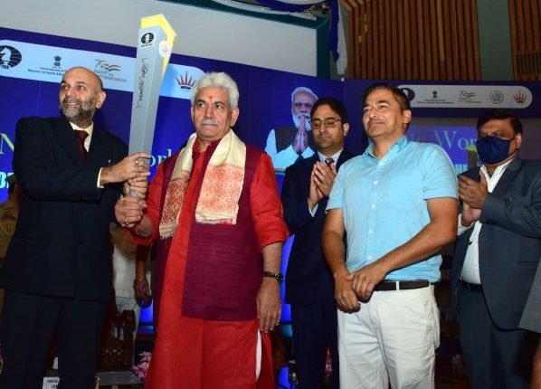 Lt Governor hands over the Chess Olympiad Torch to Chess Grandmaster Pravin Thipsay at SKICC