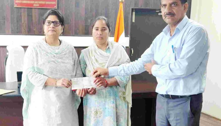 DC Reasi hands over relief cheque to family of accident victim