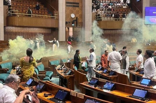Chaos Erupts in Indian Parliament as Two Individuals Breach Security, Unleashing Tear Gas During Critical Legislative Session